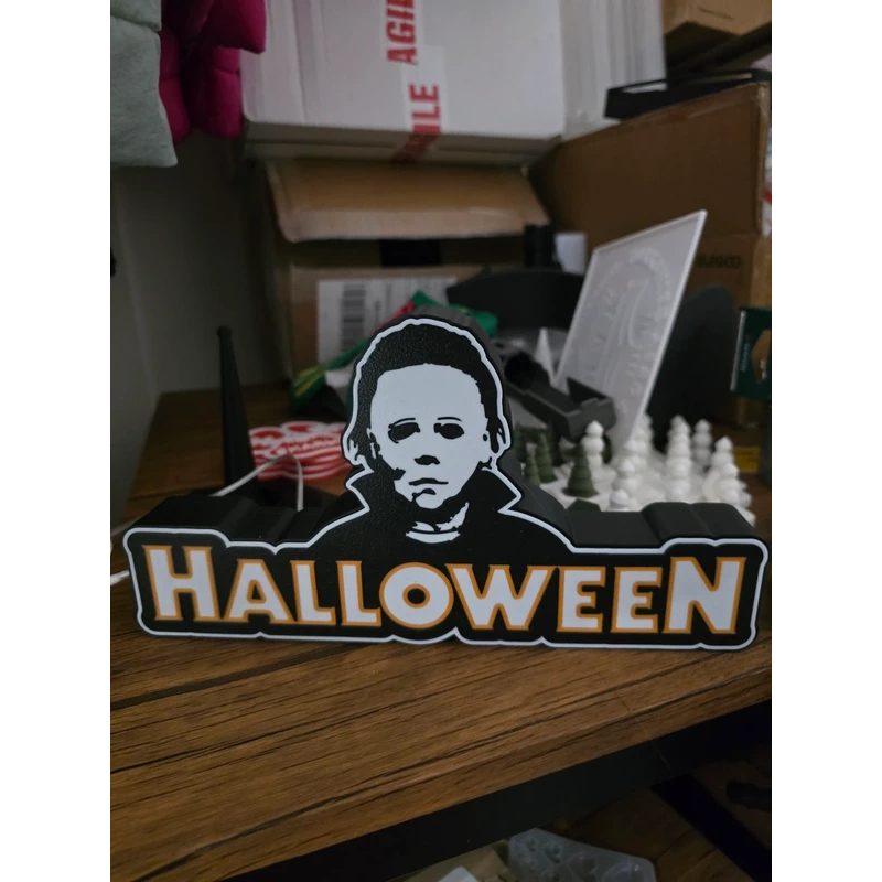 Halloween-themed Michael Myers light-up box glowing in the dark, horror collectible display with eerie silhouette—batteries not included.