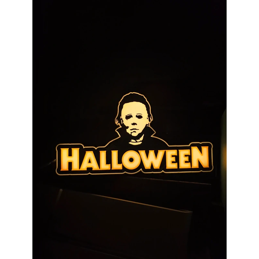 Halloween-themed Michael Myers light-up box glowing in the dark, horror collectible display with eerie silhouette—batteries not included.