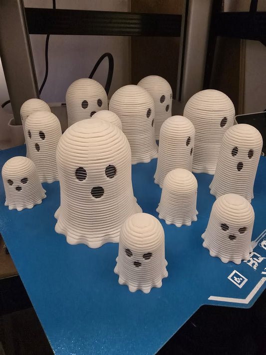 Three slinky ghost toys in small, medium, and large sizes on display