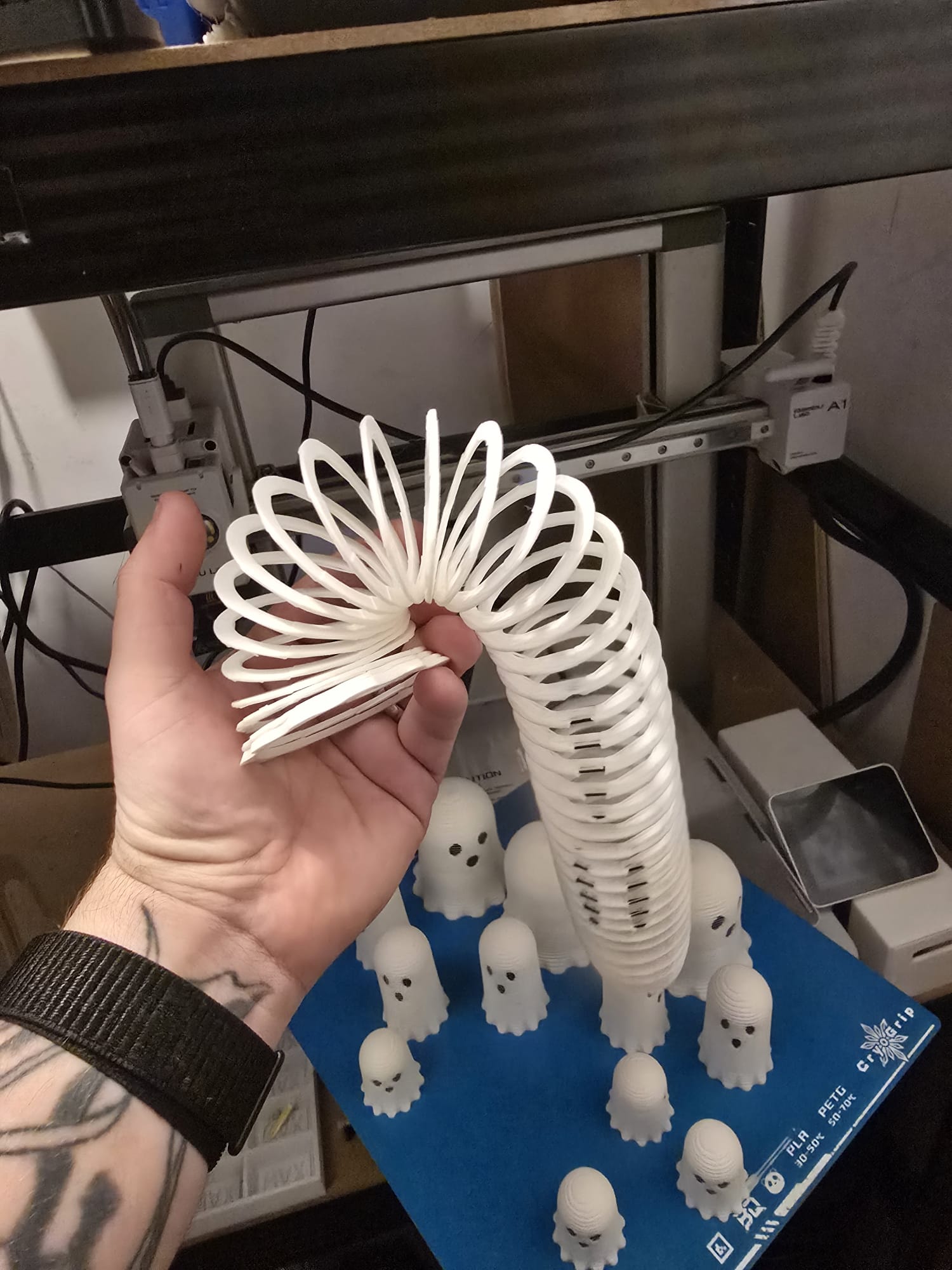 Three slinky ghost toys in small, medium, and large sizes on display