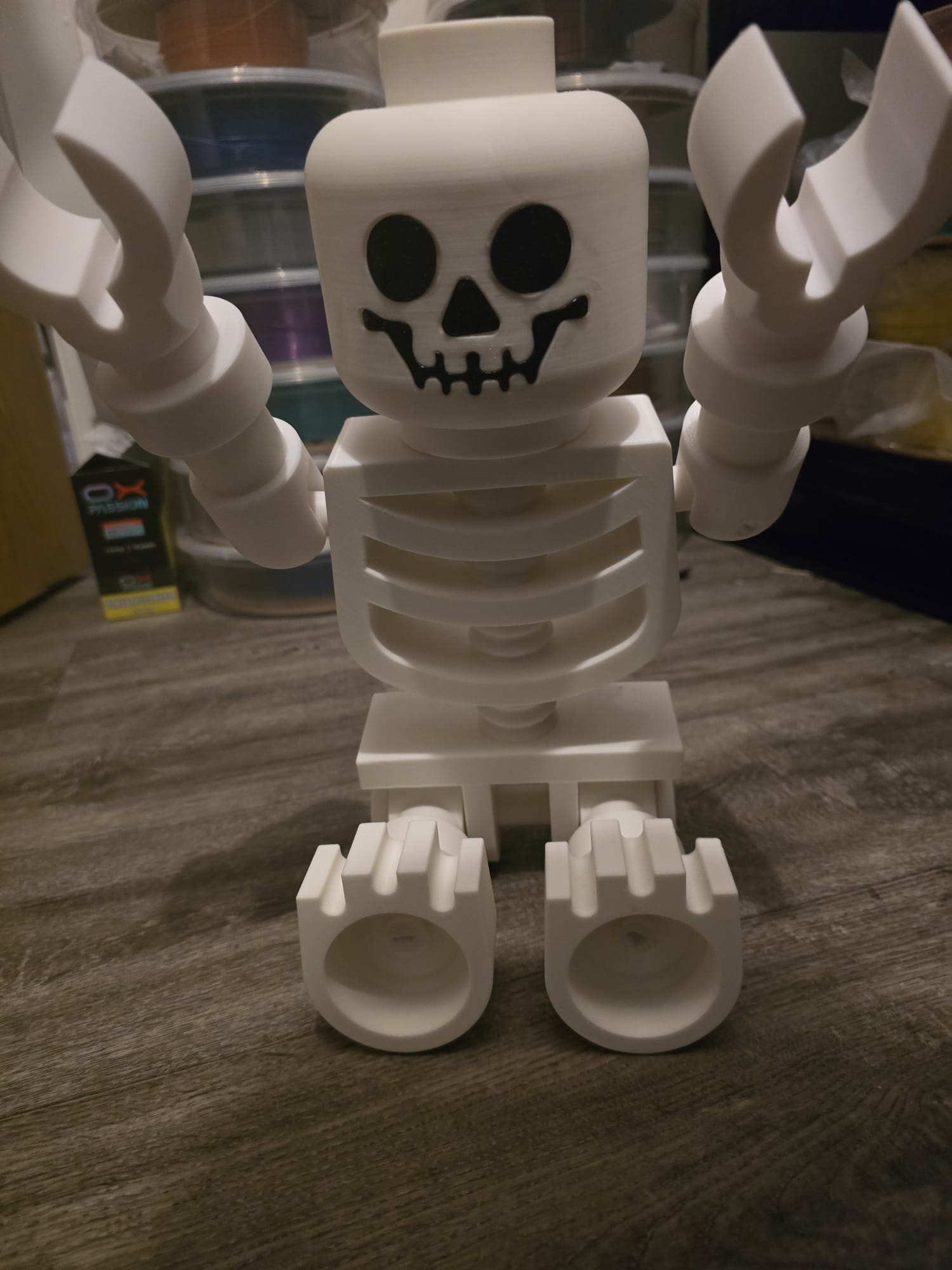Oversized LEGO-style skeleton posed with Halloween props