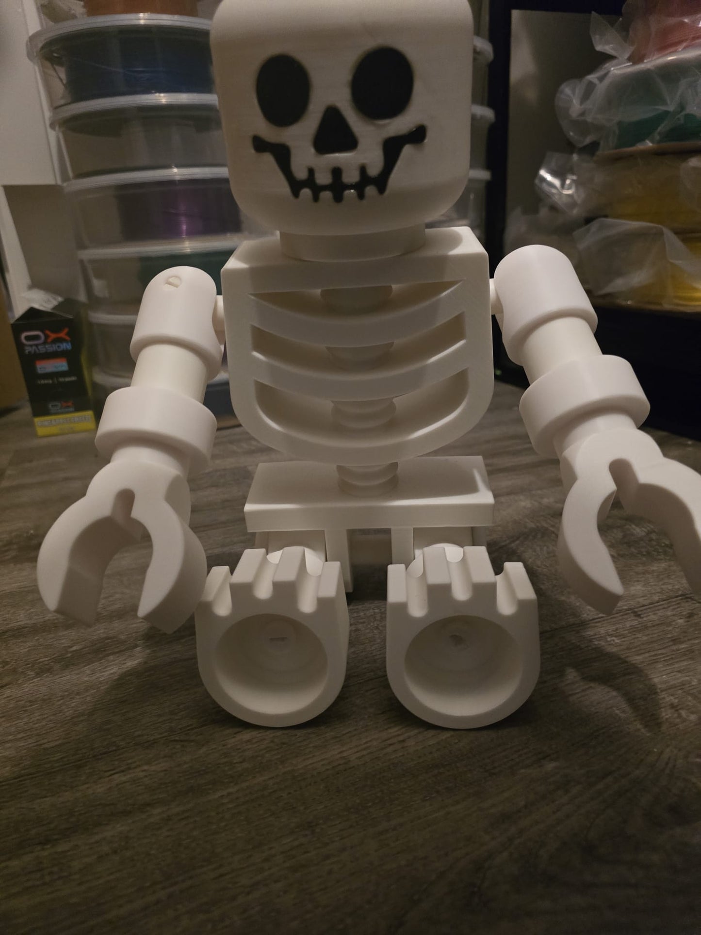 Oversized LEGO-style skeleton posed with Halloween props