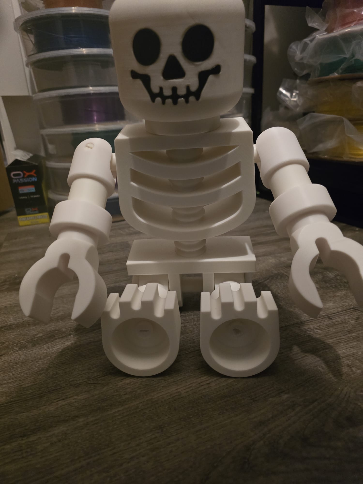 Oversized LEGO-style skeleton posed with Halloween props